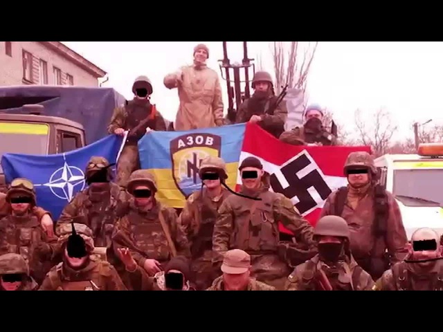 Bandera neo-Nazis of the Ukrainian Azov Battalion pose with a fascist swastika